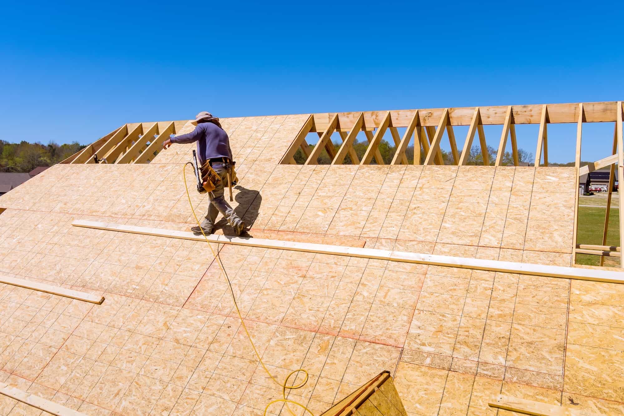 In a home roof construction crew applying roof plywood panels in New Orleans