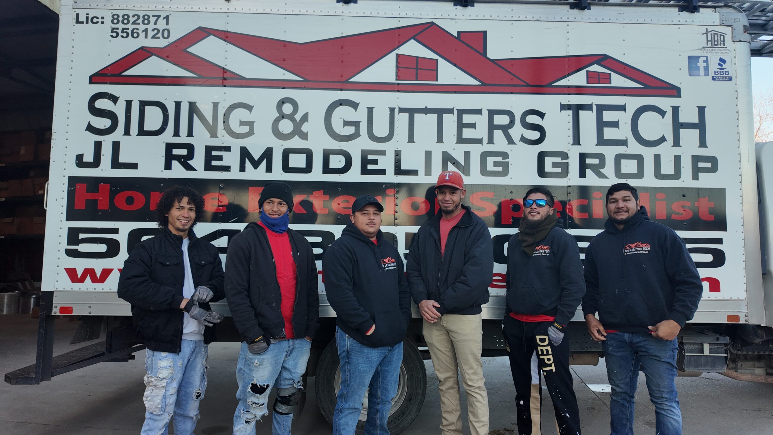 The GuttersTech (JL Remodeling Group) installation crew standing together at the company service truck -- the same team and craftsmanship standards behind our Niceville, Florida gutter and siding installs