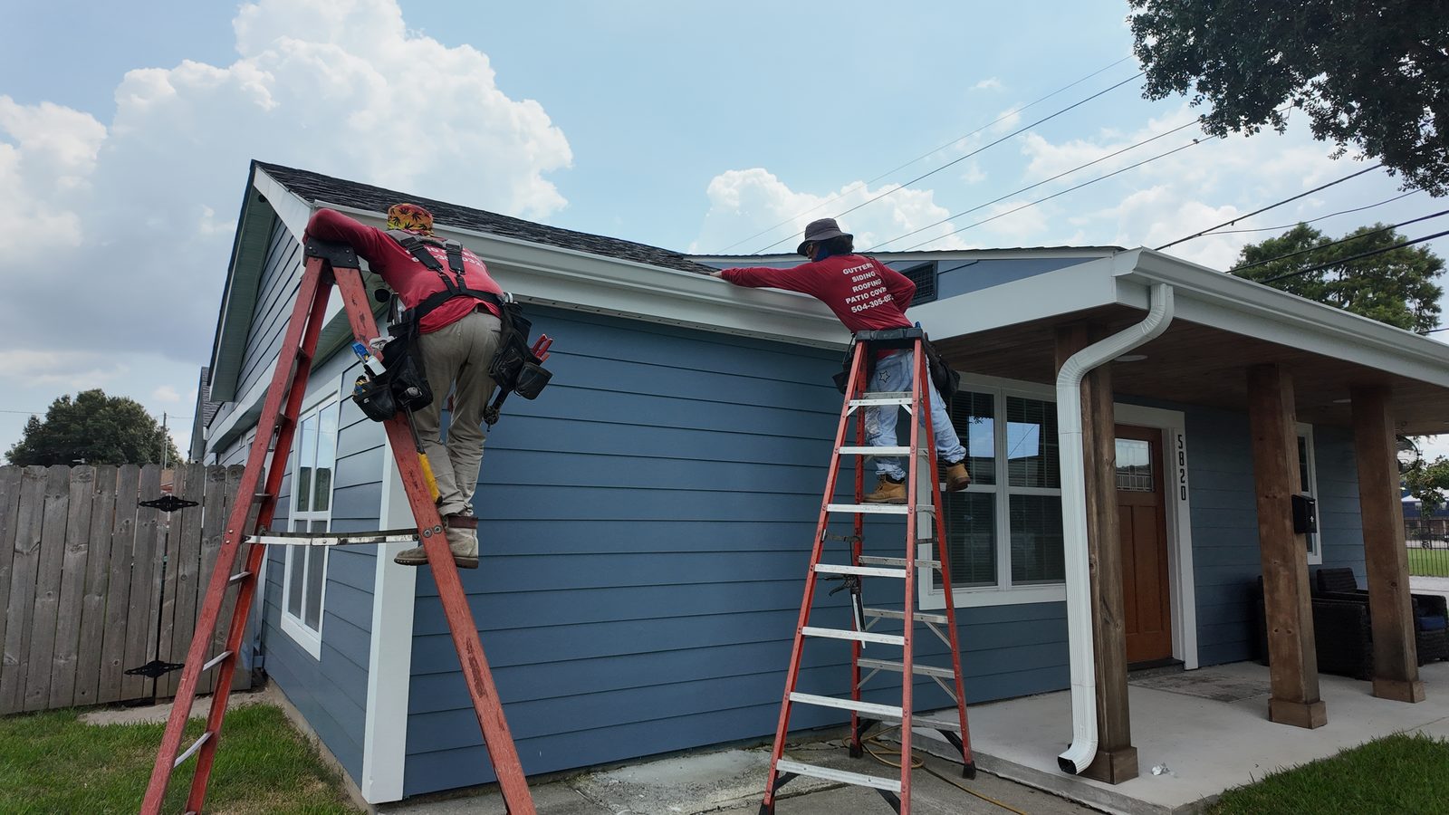 GuttersTech crew installing seamless aluminum gutters and fascia on a single-family home in the Slidell area